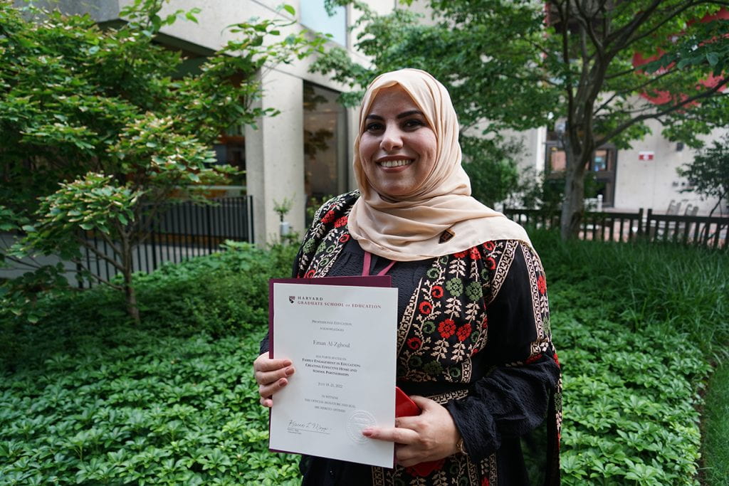 Fellow at Harvard Campus displaying program certificate